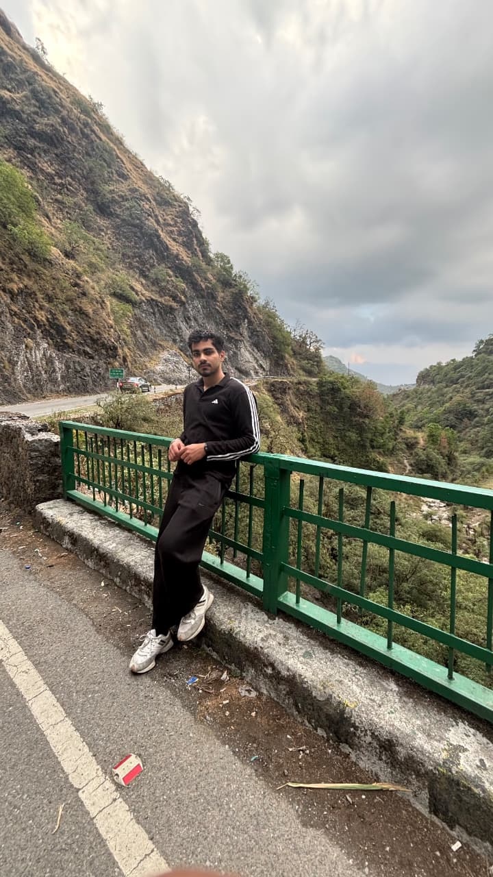 Dev on a roadside railing in the hills